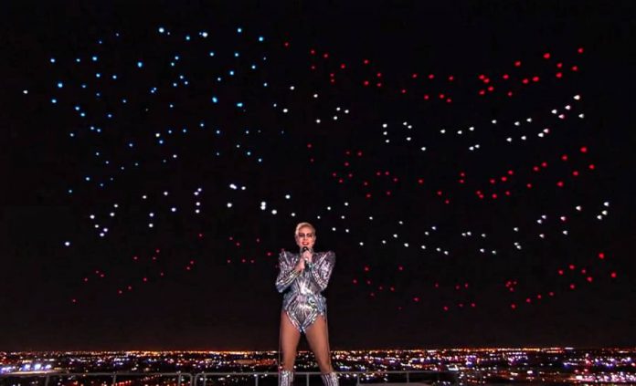 Intel drones form the United States flag behind Lady Gaga at the Super Bowl half-time show.