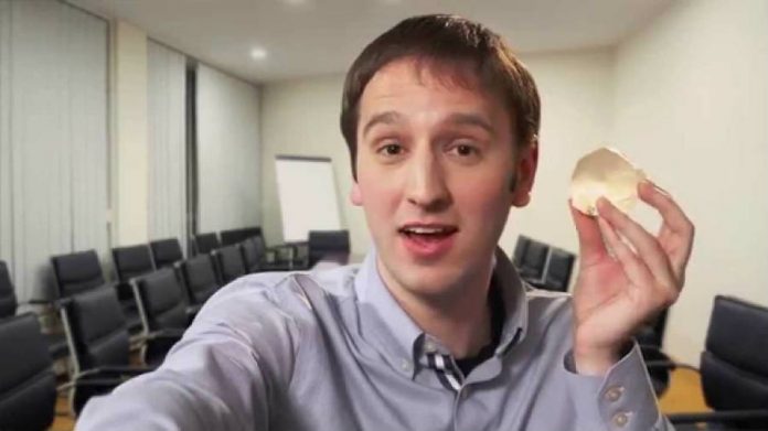 Steve Keating holding a 3D print of his brain tumor.