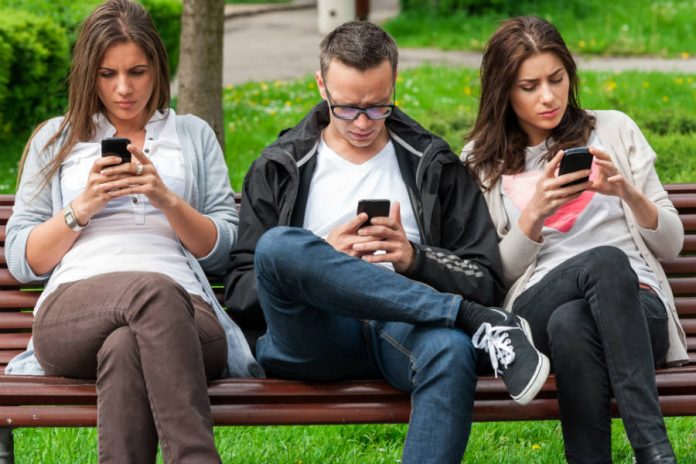 People staring at smartphones