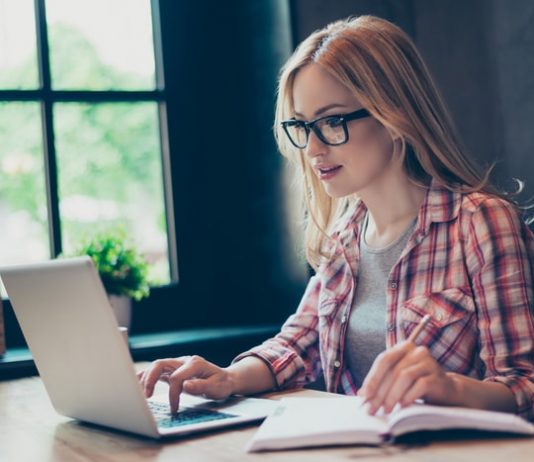 Young Woman Writing Dissertation