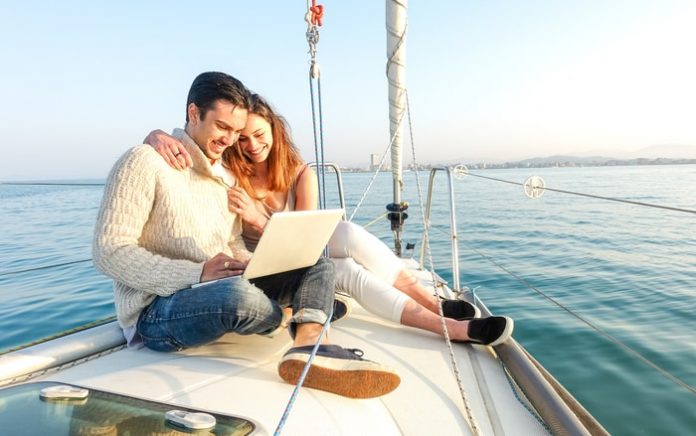 Young Couple Sailing On A Boat