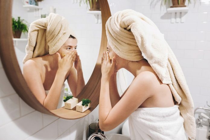 young-woman-applying-cream-face Young Woman Applying Cream to Face