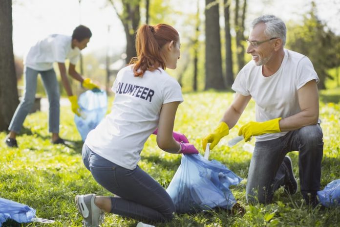 Two Volunteers Picking Up Garbage